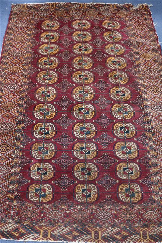 A Bokhara red ground rug 175cm x 117cm